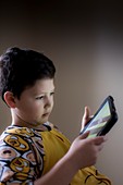 Young boy playing on handheld device