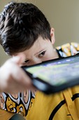 Young boy playing on handheld device