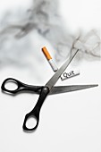 Scissors cutting cigarette