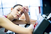 Woman resting on exercise machine