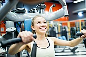 Young woman doing chest press