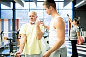 Man exercising with trainer