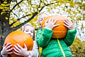 Children holding pumpkin