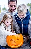 Children decorating Halloween pumpkin