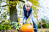 Boy with Halloween pumpkin