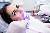 Dentist using ultraviolet light