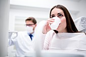 Patient rinsing in dentist's office