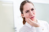 Young woman suffering toothache