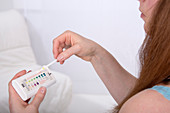 Young woman testing urine sample