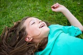 Girl lying on the grass,smiling