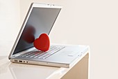 Red heart on laptop computer