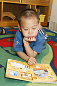 Boy Reading in Day Care