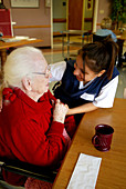 Nurse Interacting With an Elderly Woman