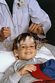 Young boy undergoing EEG examination