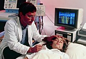 Woman patient undergoing an EEG examination