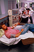 Man undergoing haemodialysis on kidney machine
