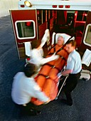 Emergency: male patient carried into ambulance