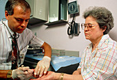 Cholesterol test: taking blood from patient