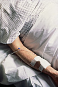 Arm of hospital patient receiving IV drip
