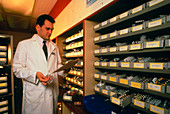 Pharmacist filling drug orders in a dispensary