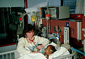 Paediatric nurse attending a meningitis patient