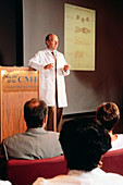 Doctor lecturing to medical professionals