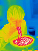 A thermogram of a boy eating hot spaghetti