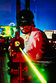 Researcher at optical bench working with a laser