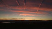 Contrails and cirrus at sunset, timelapse