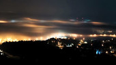 Night fog over a city, timelapse