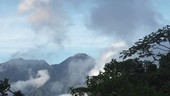 Clouds passing in front of a tropical vol