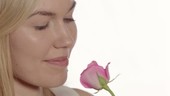 Woman smelling rose