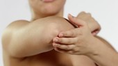 Woman rubbing elbow