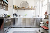 Stainless steel fronts and open-fronted shelves in kitchen