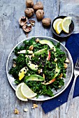 A curly kale salad with avocado, apple, walnut and black lentils