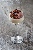 Panna cotta with chocolate curls in a dessert glass