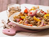 Pasta with walnut and tomato pesto and roasted peppers