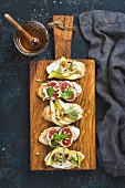 Crostini with pear, ricotta cheese, honey, figs, nuts and herbs