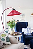 Vintage-style arc lamp with red lampshade in living room
