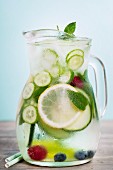 Infused water with cucumber, lemon, lime, berry and mint