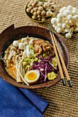 Japanese ramen soup with mushrooms, red cabbage and egg