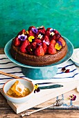 Honey cake with strawberries and horned pansies