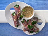 Ham and spinach rolls with sesame seed sauce and mint