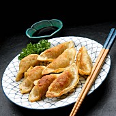 Potstickers (fried Asian dumplings) with a dip