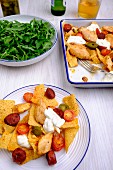 One-pot nachos with chicken, chorizo, jalapeno peppers and cherry tomatoes
