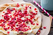 A flatbread with goats' cream cheese, pomegranate seeds and rose petals