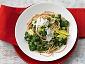 Wholemeal pasta with green sauce and Parmesan cheese