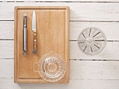 Kitchen utensils: a peeler, knife, citrus press and measuring jug