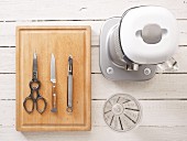 Kitchen utensils: a blender, measuring cup, pair of scissors, knife and peeler