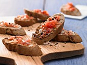 Slices of toasted bread with tomato and garlic